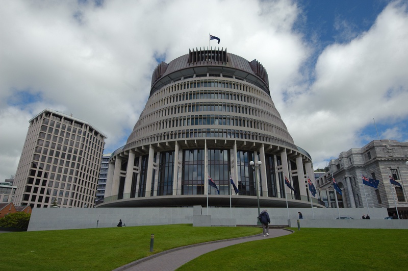 The modern, curved architecture of the building stands against a dramatic sky.
