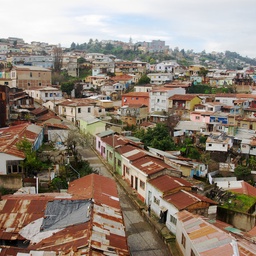 A dense cluster of colorful houses on a hillside.