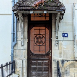 Cat sculpture on porch roof