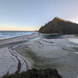 A serene beach landscape with a rocky outcrop