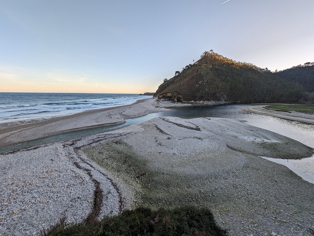 A serene beach landscape with a rocky outcrop