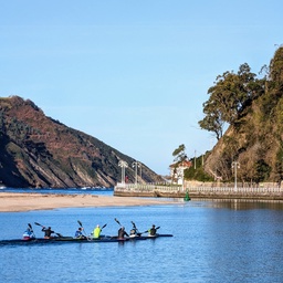 A group of kayakers paddling on a calm river