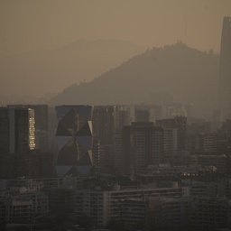 A hazy, city skyline seen through a heavy layer of smog.
