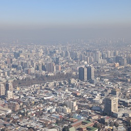 An expansive view of a hazy, urban landscape.