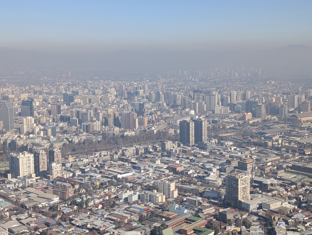An expansive view of a hazy, urban landscape.