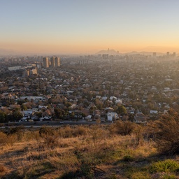 An expansive view of a city at sunset.