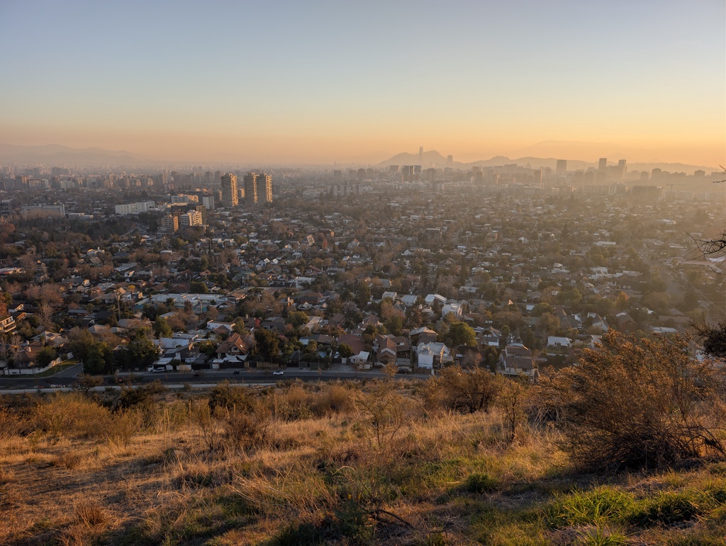 An expansive view of a city at sunset.