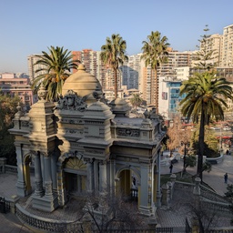 An ornate, classical-style pavilion in an urban park setting.