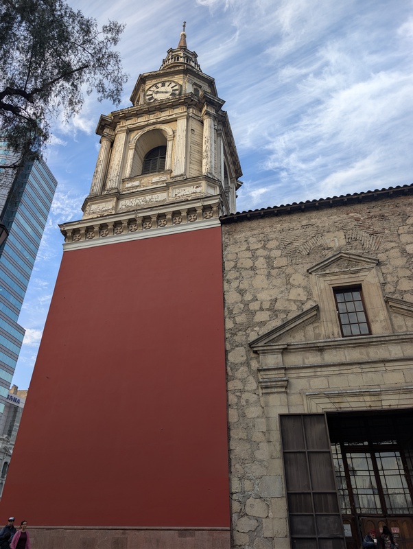 An old clock tower in a city square.