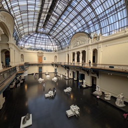 A large museum atrium with a glass ceiling.