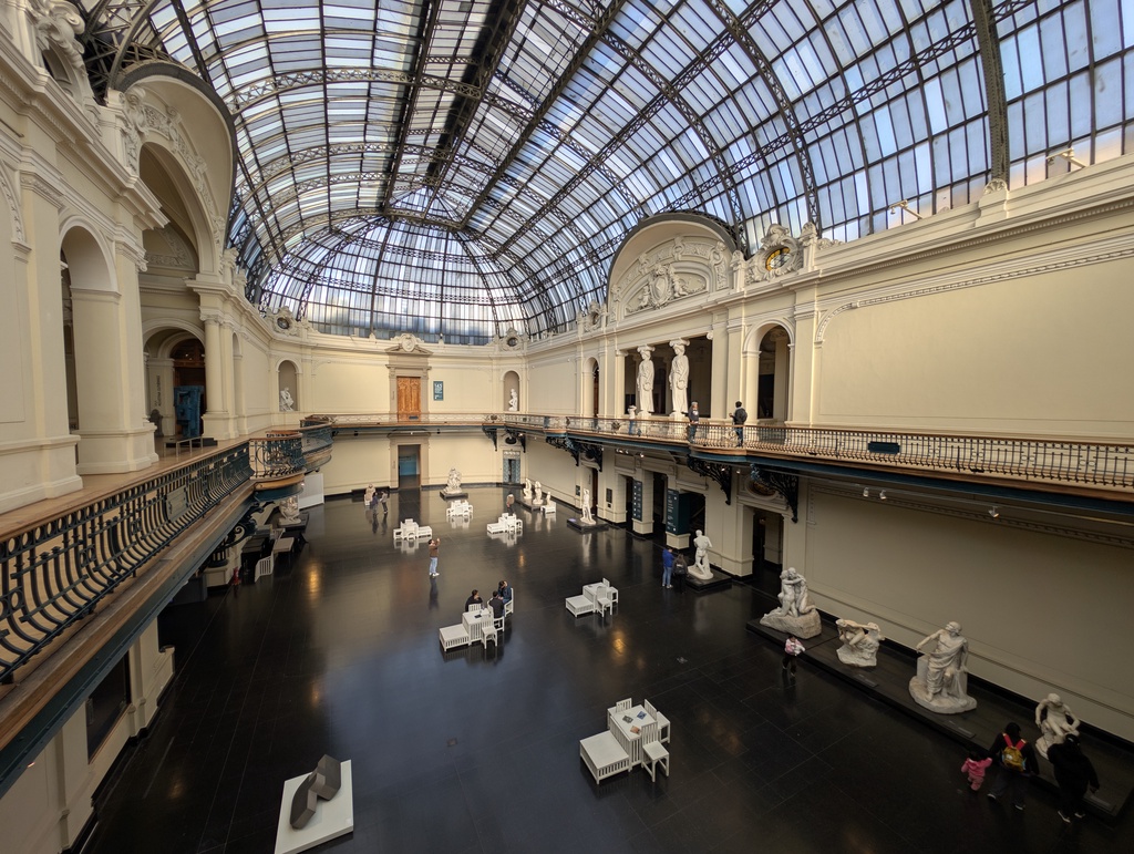 A large museum atrium with a glass ceiling.
