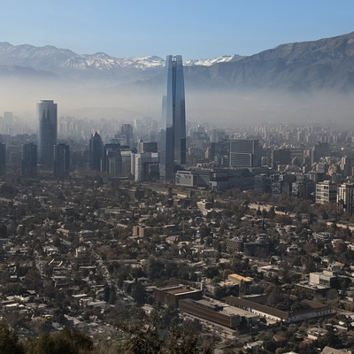 A large skyscraper in a hazy, urban landscape.