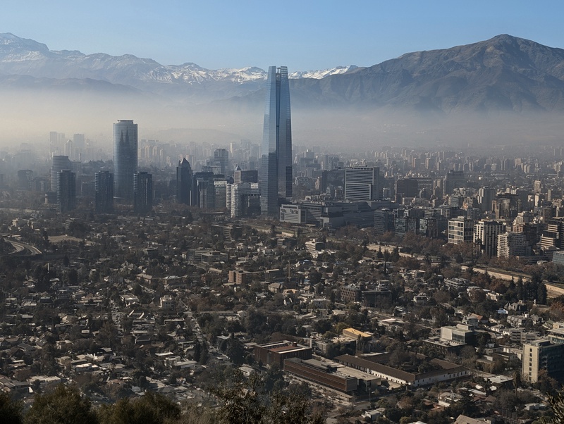 A large skyscraper in a hazy, urban landscape.