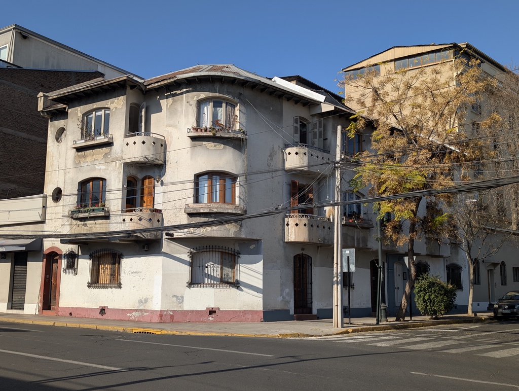 An old, multi-story building on a street corner.