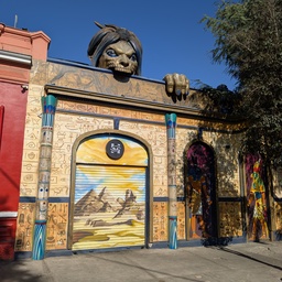 An ornate, decorated building with a large animal head sculpture on top.