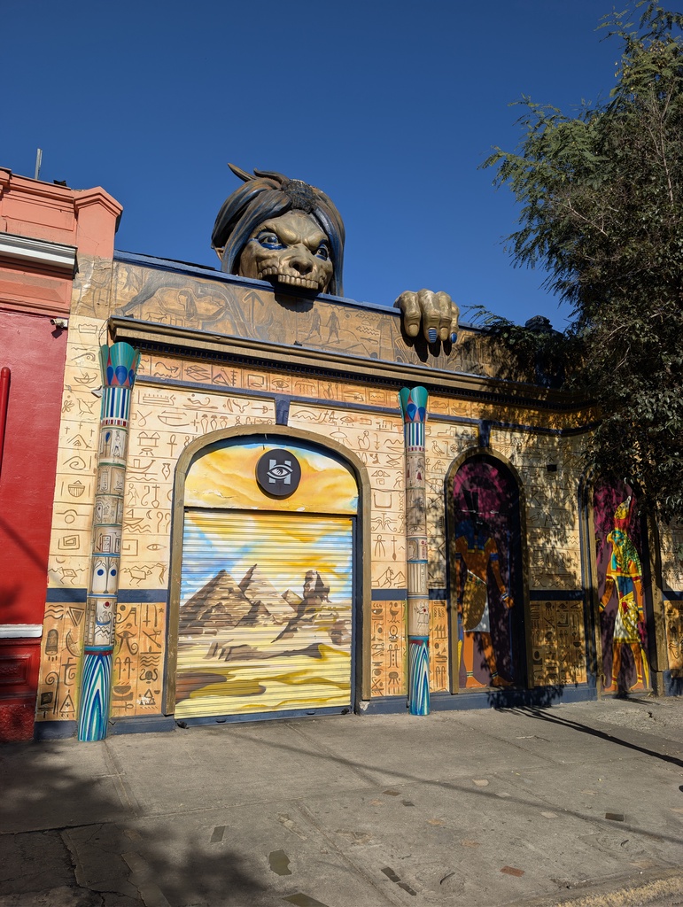 An ornate, decorated building with a large animal head sculpture on top.