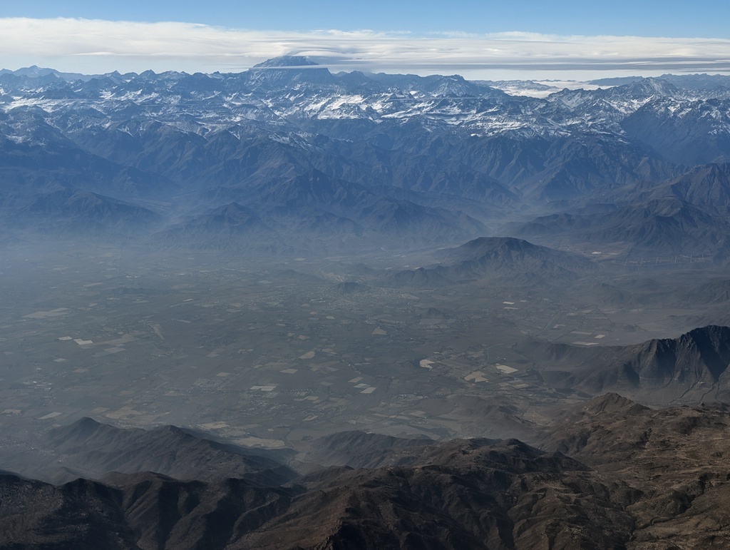 Snow-capped mountains under a blue sky.