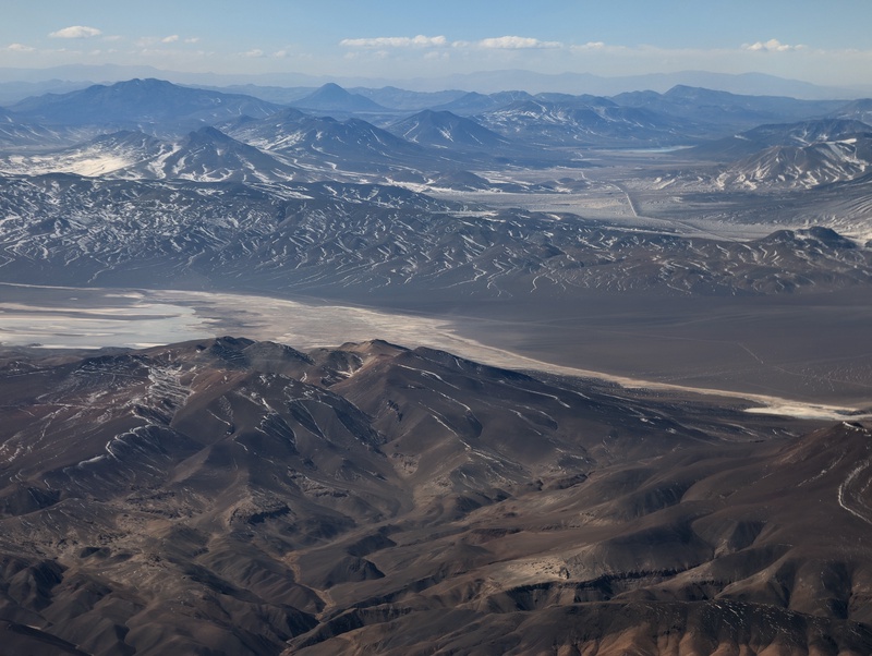 An aerial view of a vast, arid mountain range.