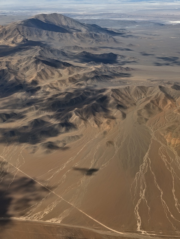 An aerial view of a barren, mountainous landscape.