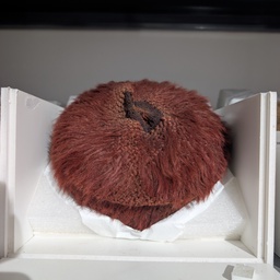 A reddish brown furry hat