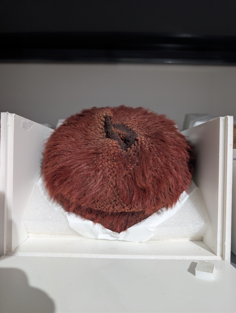 A reddish brown furry hat